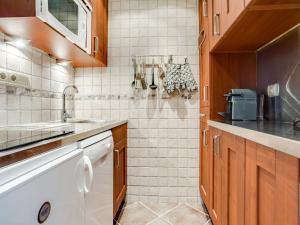 a kitchen with a sink and a counter at Apartment Le Prariond - Val Claret-10 by Interhome in Tignes +13 photos
