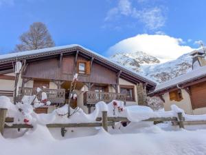 una casa cubierta de nieve con una valla en Apartment Le Plan des Reines by Interhome, en Chamonix-Mont-Blanc