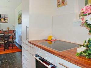 a kitchen with white cabinets and a counter top at Apartment Casablanca OG by Interhome in San Nazzaro