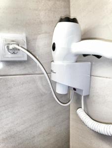 a security camera attached to a wall with a cord at APARTMENTS HARIS in Olympiaki Akti