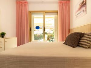 A bed or beds in a room at Apartment Golf Sant Jordi by Interhome