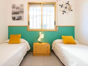 A bed or beds in a room at Apartment Golf Sant Jordi by Interhome