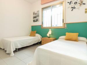 A bed or beds in a room at Apartment Golf Sant Jordi by Interhome