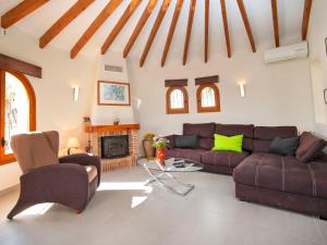 a living room with a couch and a fireplace at Holiday Home Lolita by Interhome in Pedramala