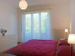 a bedroom with a purple bed and a window at Apartment Large Suite-20 by Interhome in Ascona +16 photos