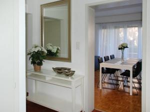 a dining room with a white table and a mirror at Apartment Large Suite-20 by Interhome in Ascona