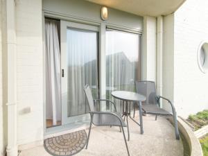 a balcony with a table and chairs and a window at Apartment Blutsyde Promenade-29 by Interhome in Mispelburg