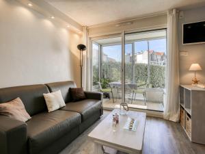 a living room with a couch and a table at Apartment Port Arcachon-1 by Interhome in Arcachon