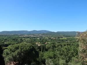 a view of a forest with mountains in the background at Apartment Les Terrasses de Grimaud by Interhome in Grimaud