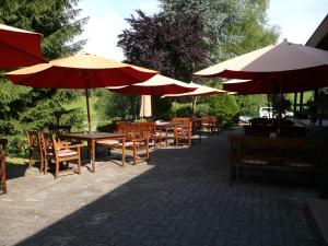 a group of tables and chairs with umbrellas at Flörsbacher Hof in Flörsbachtal