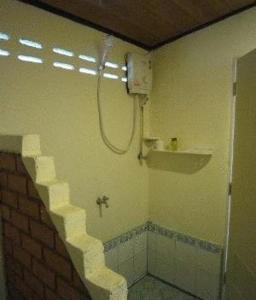 a bathroom with a shower and a brick wall at Moonwalk Lanta Resort in Ko Lanta