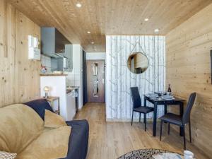 a living room with a couch and a table with chairs at Studio Le Curling A - Val Claret-21 by Interhome in Tignes +11 photos