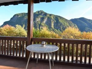 a table on a porch with a view of a mountain at Apartment Villa Bellavista by Interhome in Campitello di Fassa