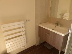 a bathroom with a sink and a mirror at L'Esquirou in Grasse