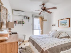 a bedroom with a bed and a ceiling fan at Apartment Le Newport-2 by Interhome in Fréjus