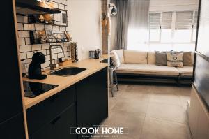 a kitchen with a couch in a room at Gook Home BEACH in Málaga