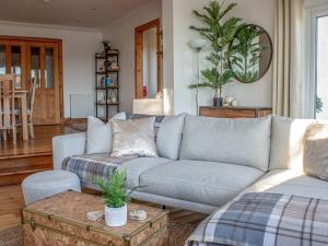 a living room with a couch and a table at Holiday Home Bay View by Interhome in Uig