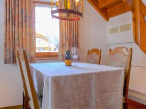 a dining room table with a bottle of wine on it at Apartment Casa Pia-2 by Interhome in Zermatt