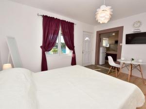 a bedroom with a white bed and a window at Holiday Home Ana-2 by Interhome in Obrovac
