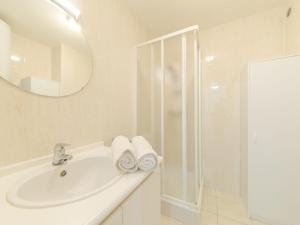 a white bathroom with a sink and a shower at Apartment Residentie Cannes 208 by Interhome in Bredene