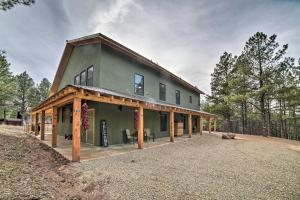 a large green house with a gambrel roof at Family Home with Fire Pit and Grill about 1 Mi to Slopes! in Angel Fire