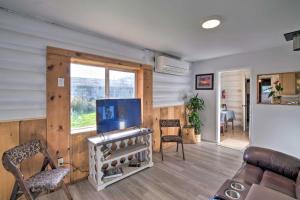 a living room with a fireplace and a couch and a window at Unique Dog-Friendly Log Cabin Short Walk to Ocean in Crescent City