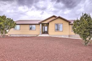 a house with a large driveway in front of it at Show Low Home with White Mountain Lake Access! in White Mountain Lakes Estates