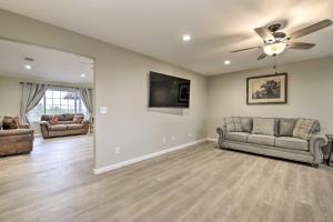 a living room with two couches and a flat screen tv at Show Low Home with White Mountain Lake Access! in White Mountain Lakes Estates