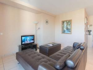 a living room with a couch and a tv at Apartment Firenze 108 with parking by Interhome in Bredene