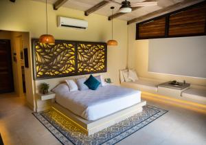 a bedroom with a bed and a bench in a room at Hotel La Finca Buritaca by DOT Premium in Buritaca