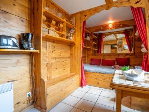 a log cabin with a bed in a room at Studio Soyouz Vanguard-92 by Interhome in Le Corbier
