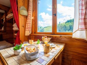 a table with food on it in a room with a window at Studio Soyouz Vanguard-92 by Interhome in Le Corbier
