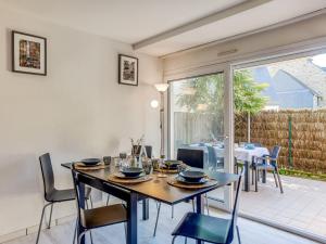 a dining room with a table and chairs at Apartment Le Parc des Druides-3 by Interhome in Carnac