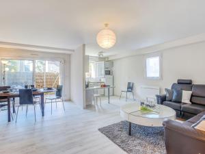 a living room with a couch and a table at Apartment Le Parc des Druides-3 by Interhome in Carnac