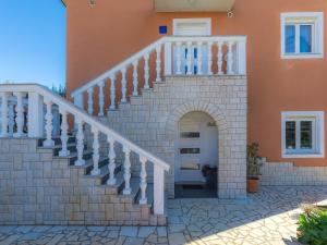 a staircase leading up to a house with a white door at Apartment Laura by Interhome in Galižana