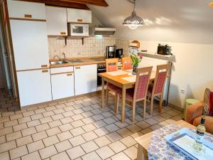 a kitchen with a table and chairs in a room at Apartment Peters-2 by Interhome in Barkholt