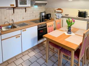 a kitchen with a wooden table and a sink at Apartment Peters-2 by Interhome in Barkholt