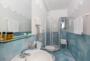a bathroom with a sink and a toilet and a shower at Hotel Al Mulino in Anacapri