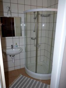 a bathroom with a shower and a sink at Dorka vendégház in Kehidakustány