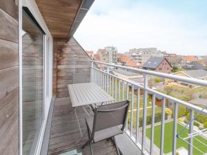 a balcony with a chair and a table on it at Apartment Paul's parklane by Interhome in Bredene