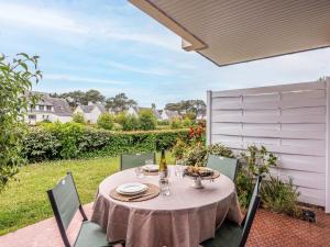 a table and chairs on the patio of a house at Studio Village de Légenèse by Interhome in Carnac