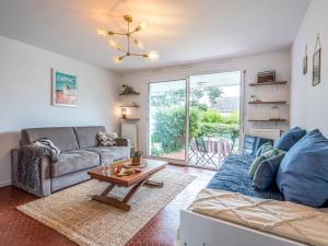 a living room with a couch and a table at Studio Village de Légenèse-4 by Interhome in Carnac