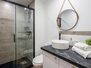 a bathroom with a toilet and a sink and a mirror at Studio Village de Légenèse by Interhome in Carnac