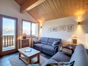 a living room with a couch and a table at Chalet Le Dahu by Interhome in Veysonnaz