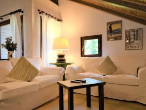 a living room with two white couches and a table at Apartment Chesa Seglias 6 by Interhome in Surlej +19 photos