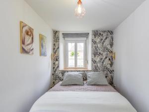 a small bedroom with a bed and a window at Holiday Home L'oyat by Interhome in Pirou +14 photos