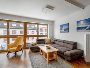 a living room with a couch and a table at Apartment Papa Joe's Kuschelappartements-2 by Interhome in Schladming