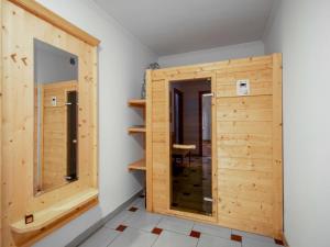 a wooden door in a room with a mirror at Apartment Papa Joe's Kuschelappartements-2 by Interhome in Schladming