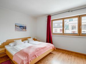 a bedroom with a bed and a window at Apartment Papa Joe's Kuschelappartements-1 by Interhome in Schladming