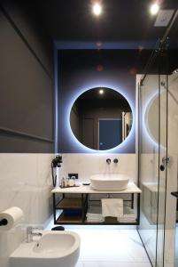 a bathroom with a sink and a mirror at Fingerprint Luxury Apartments in Zagreb